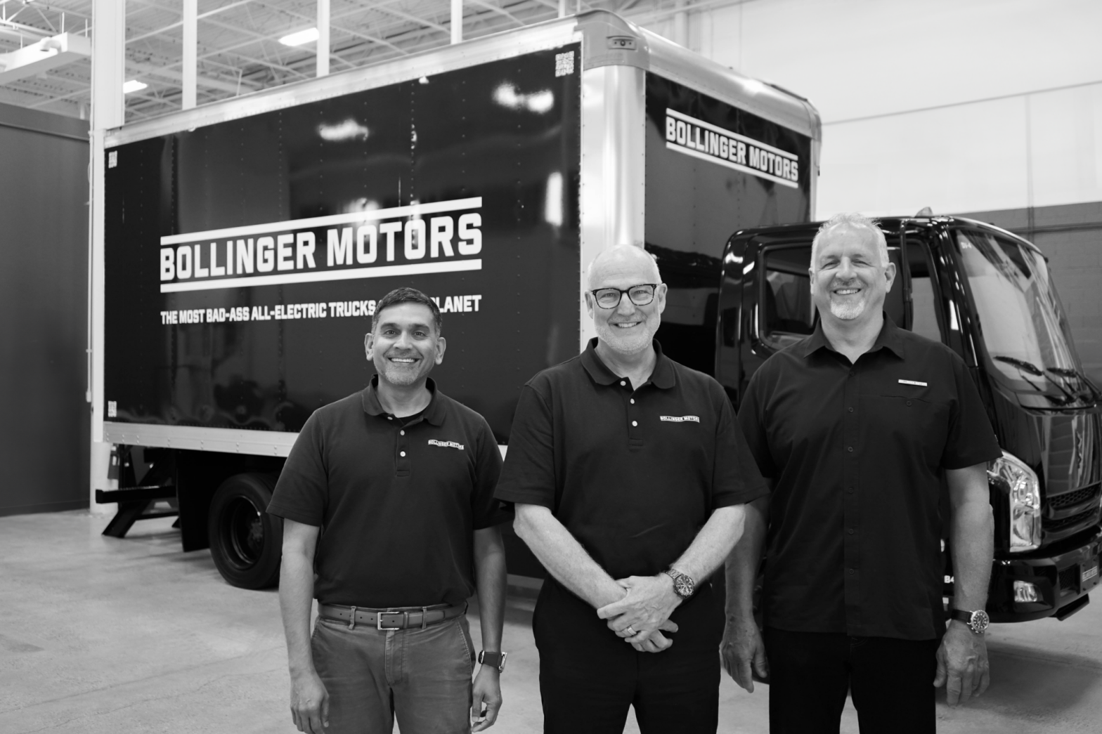In a black and white picture, from left to right: Siva Kumar, James Taylor, Bryan Chambers in front of a truck